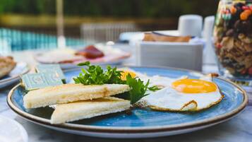A breakfast plate with toast and a fried egg on a blue plate.