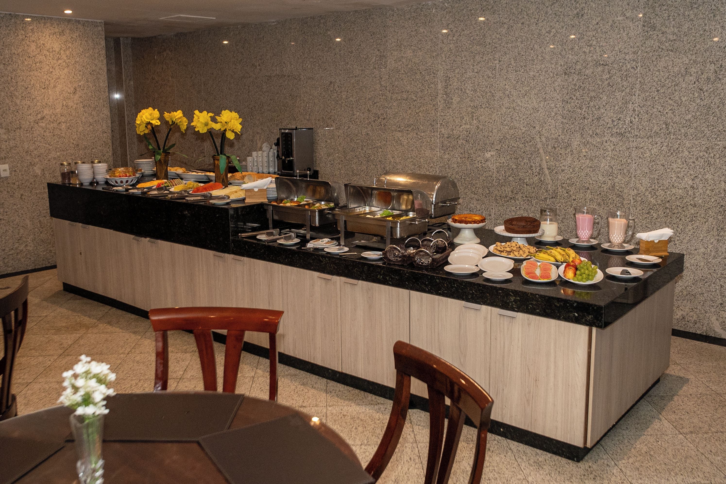 A modern kitchen with a central island, equipped with various appliances and food items.
