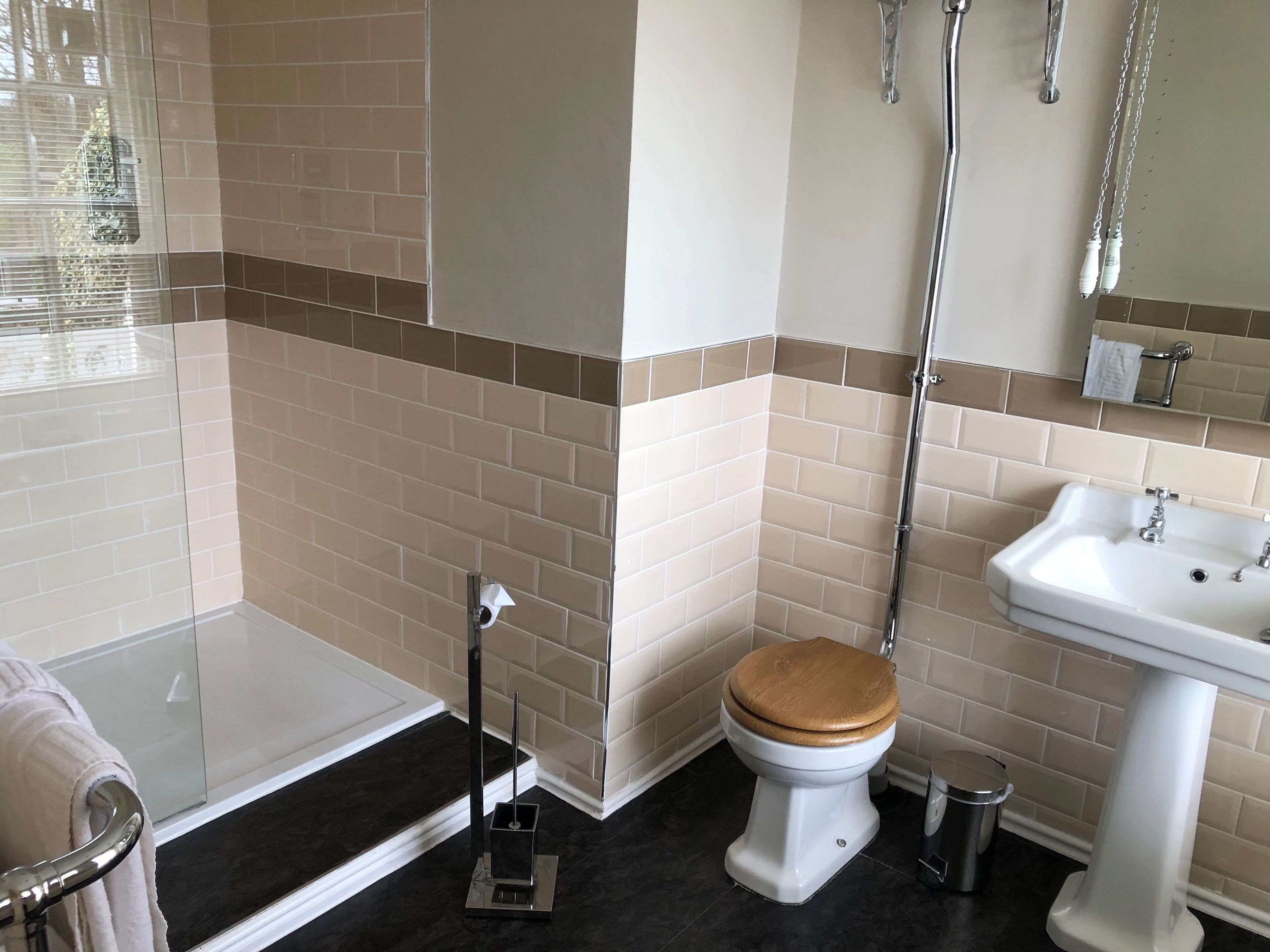 A bathroom with a toilet, sink, and shower.