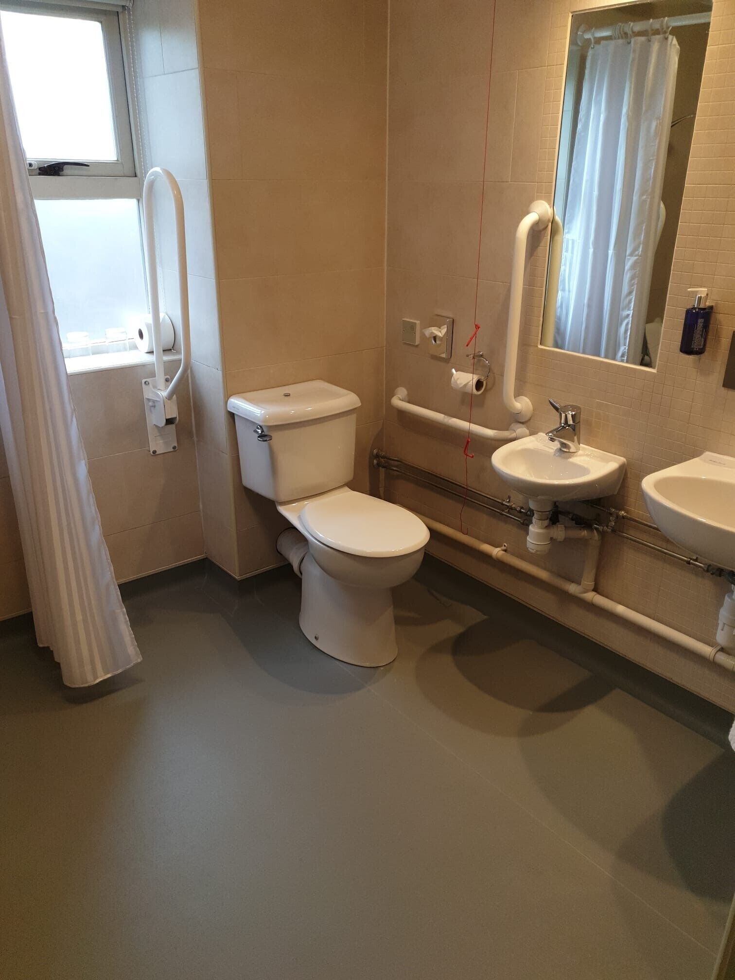 A modern bathroom with a toilet, bidet, and sink.