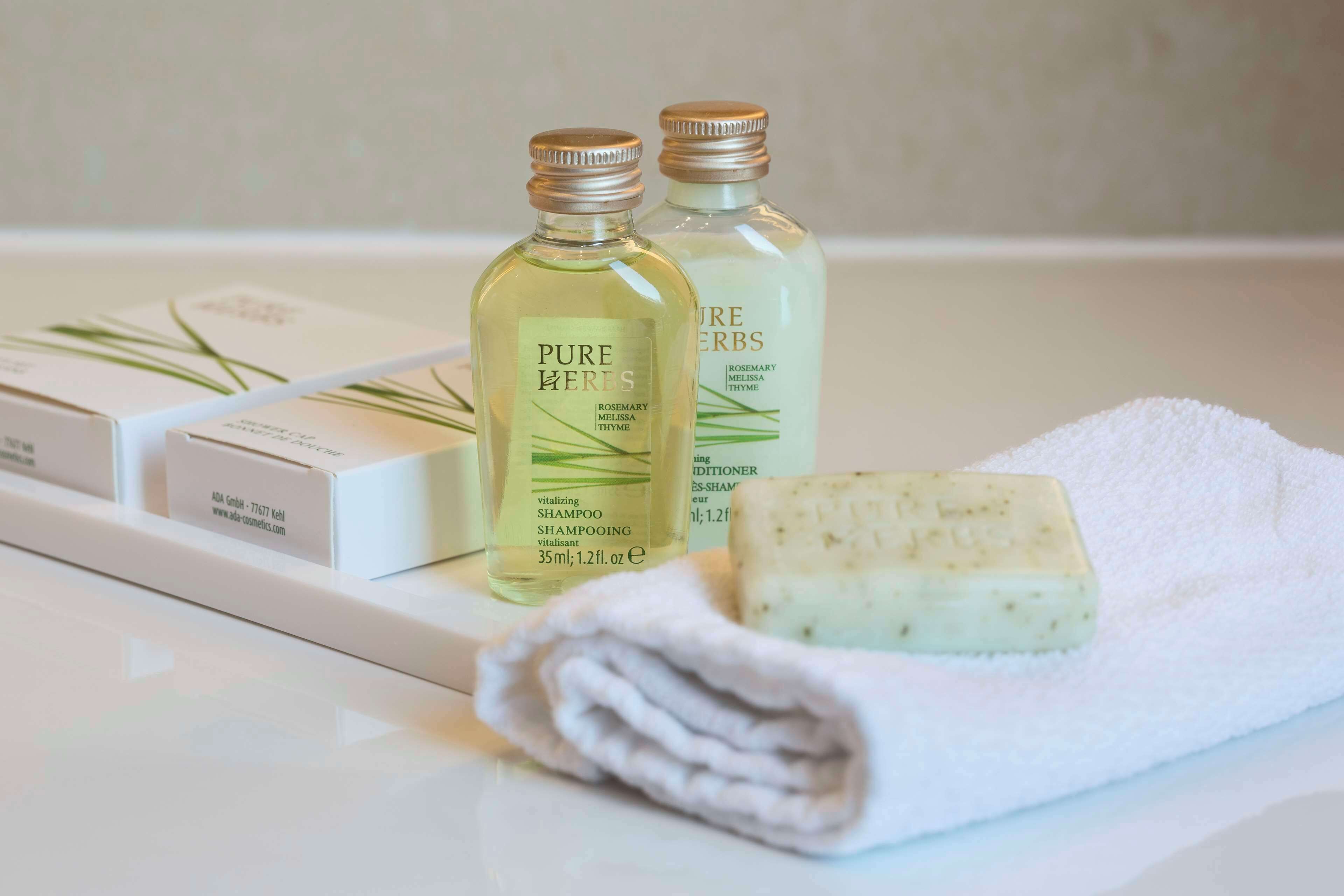 designer toiletries, hair dryer, bathrobes, slippers