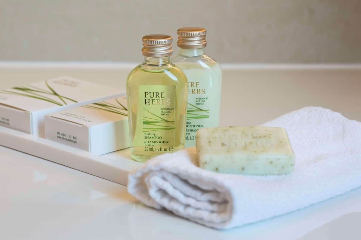 designer toiletries, hair dryer, bathrobes, slippers