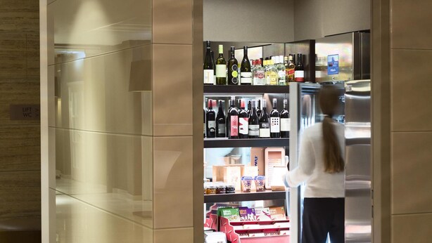 A modern hotel lobby with a wine and spirits section, a lift, and a seating area. - The Harmonie Vienna, BW Premier Collection (Vienna)