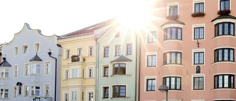 A row of colorful historic buildings with balconies and a street lamp.