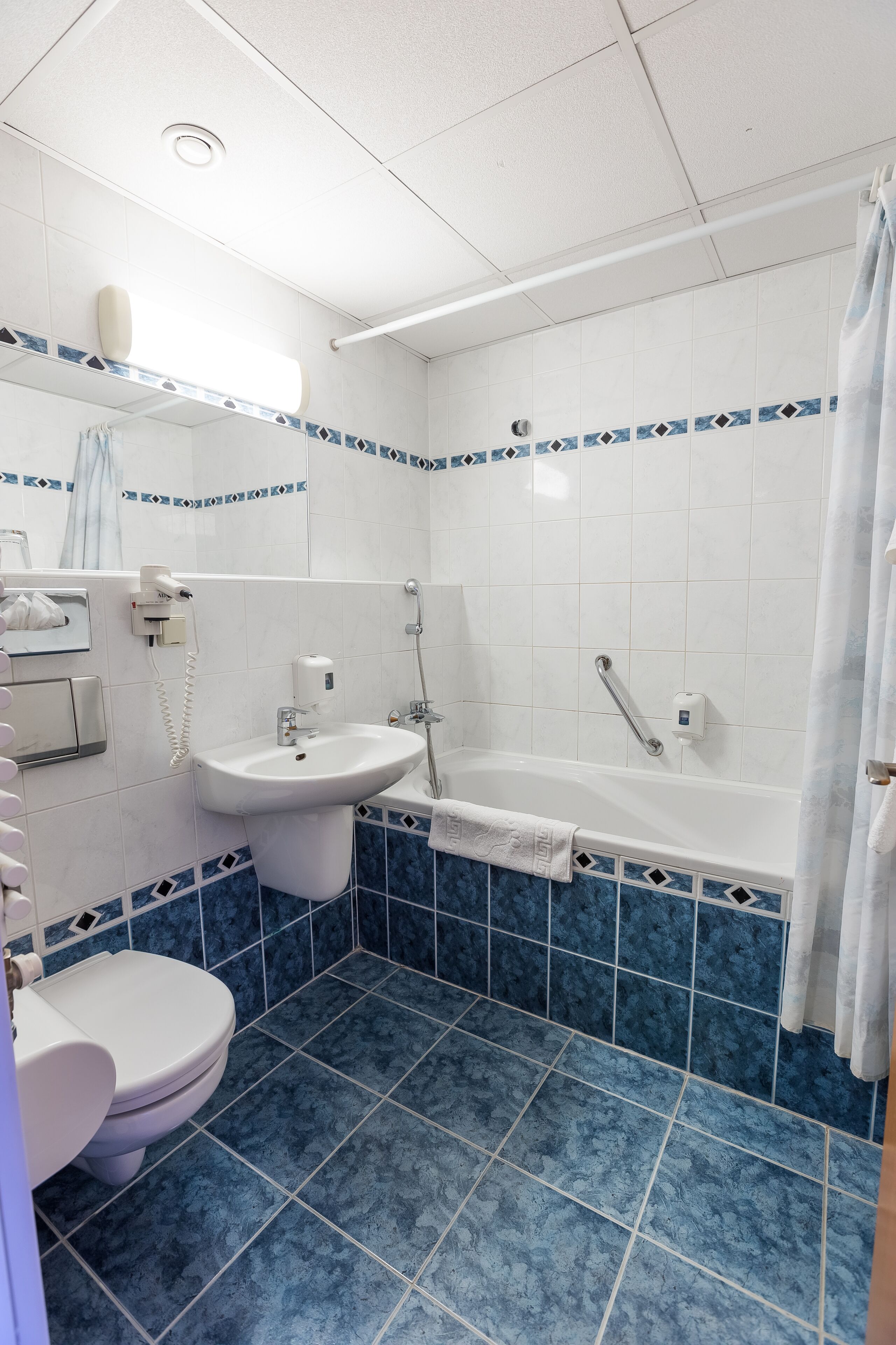 superior double room | bathroom | shower, hair dryer, towels