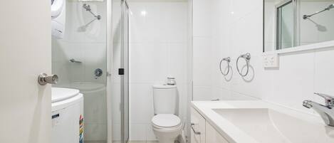 A modern bathroom with a toilet, bidet, and shower.