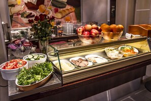 A buffet with various food items including fruits, vegetables, and salads. - Best Western Hotel Apollo (Oulu)