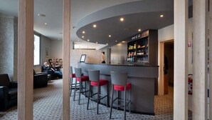 Zona de bar con mostrador curvo, taburetes y una sección para llevar.