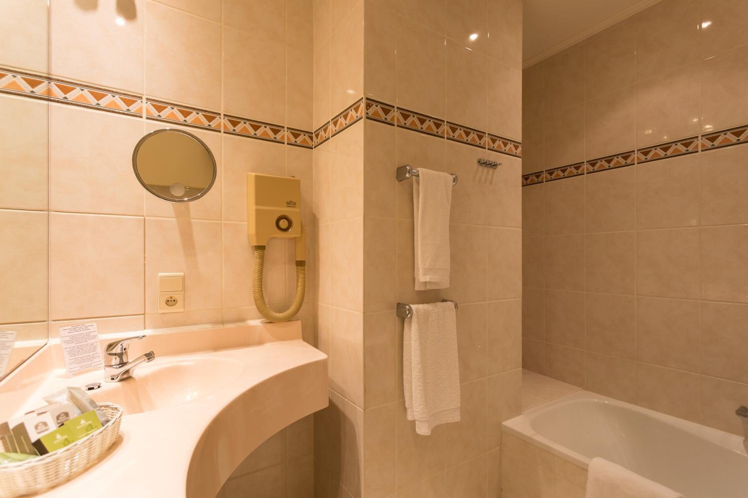 shower, hair dryer, slippers, towels