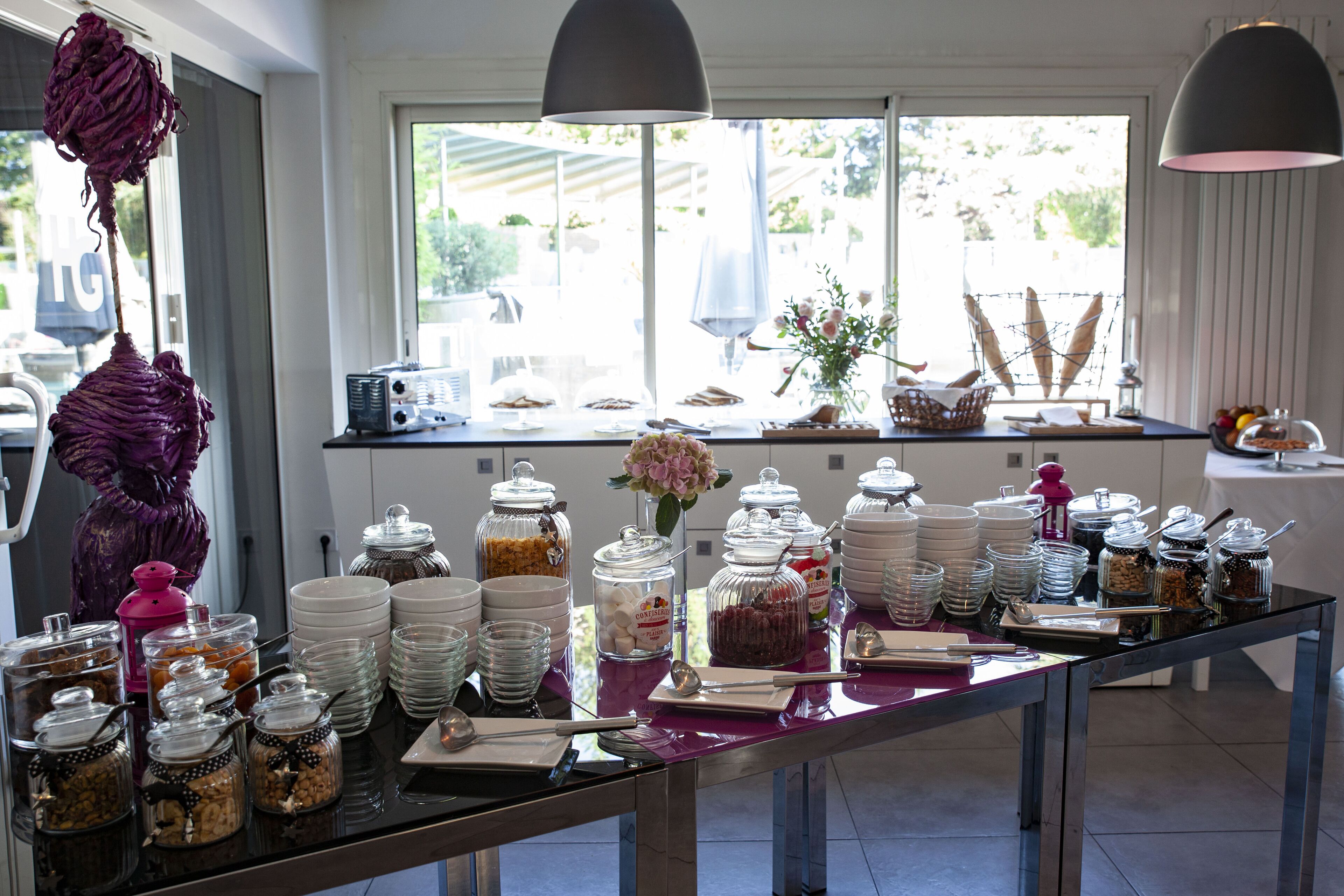 A buffet setup with various food items and utensils.