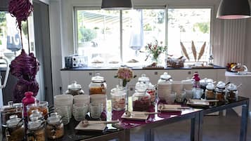 A buffet setup with various food items and utensils.
