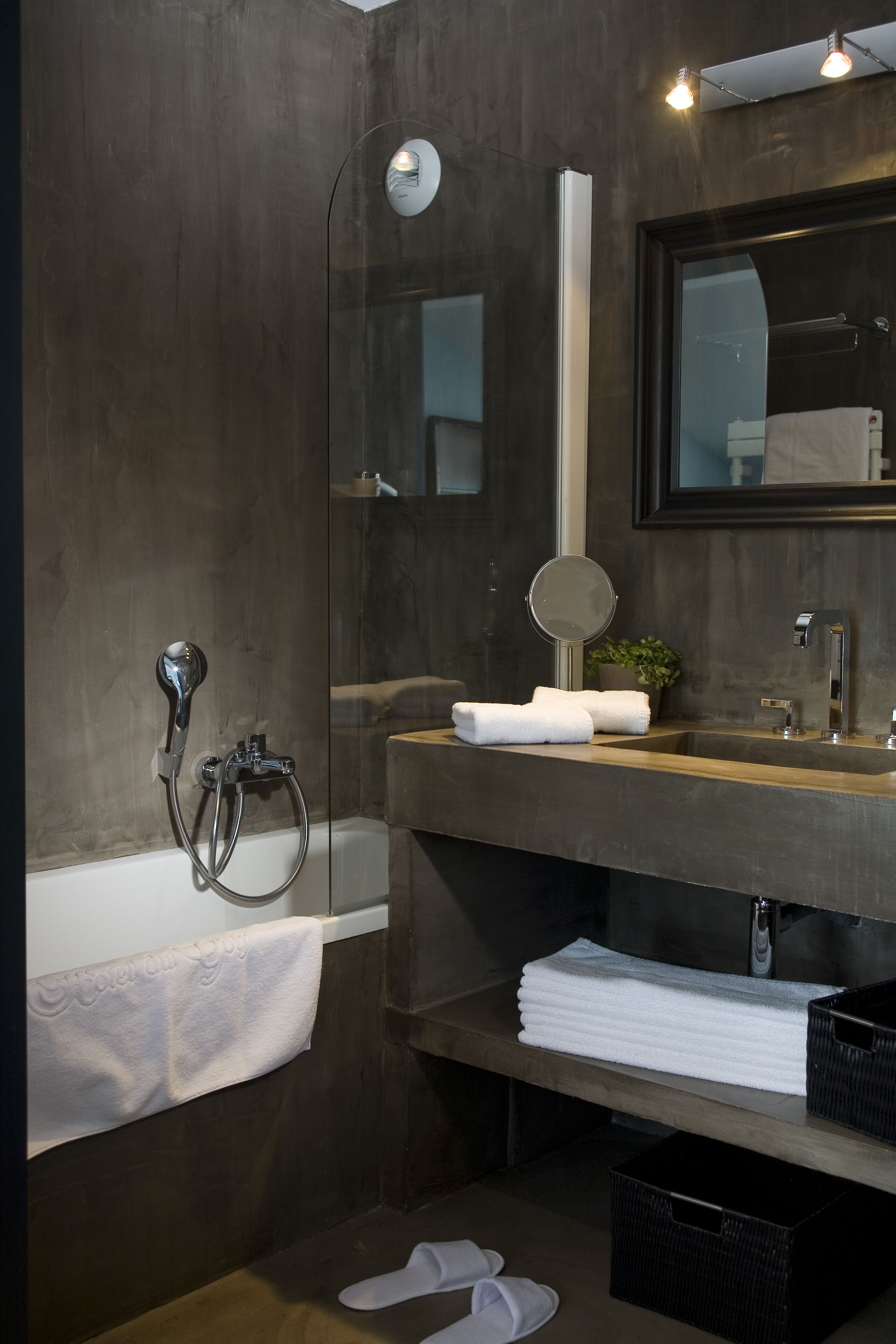 A modern bathroom with a bathtub, a sink with a mirror, and a towel rack.
