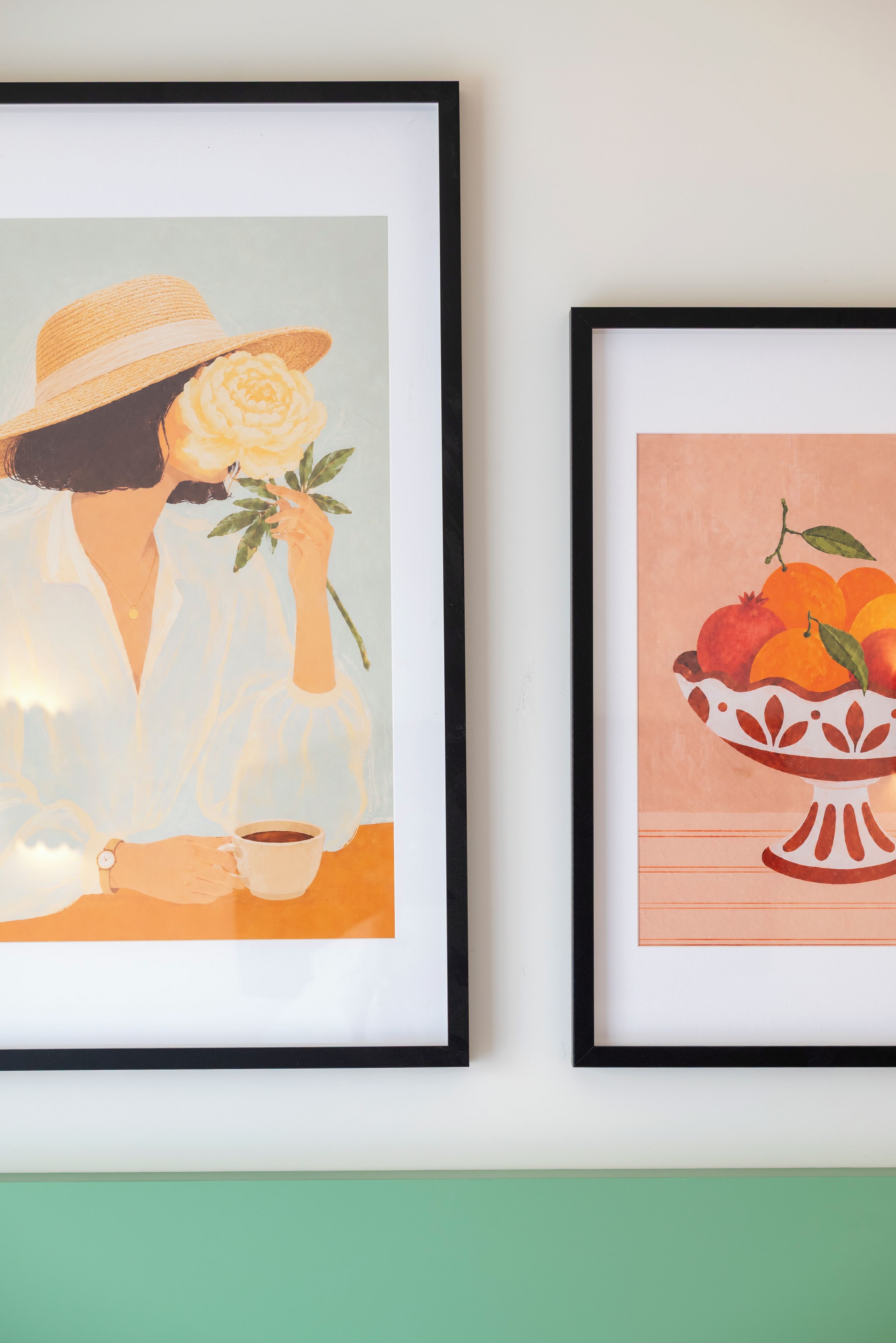 Two framed artworks on a wall.