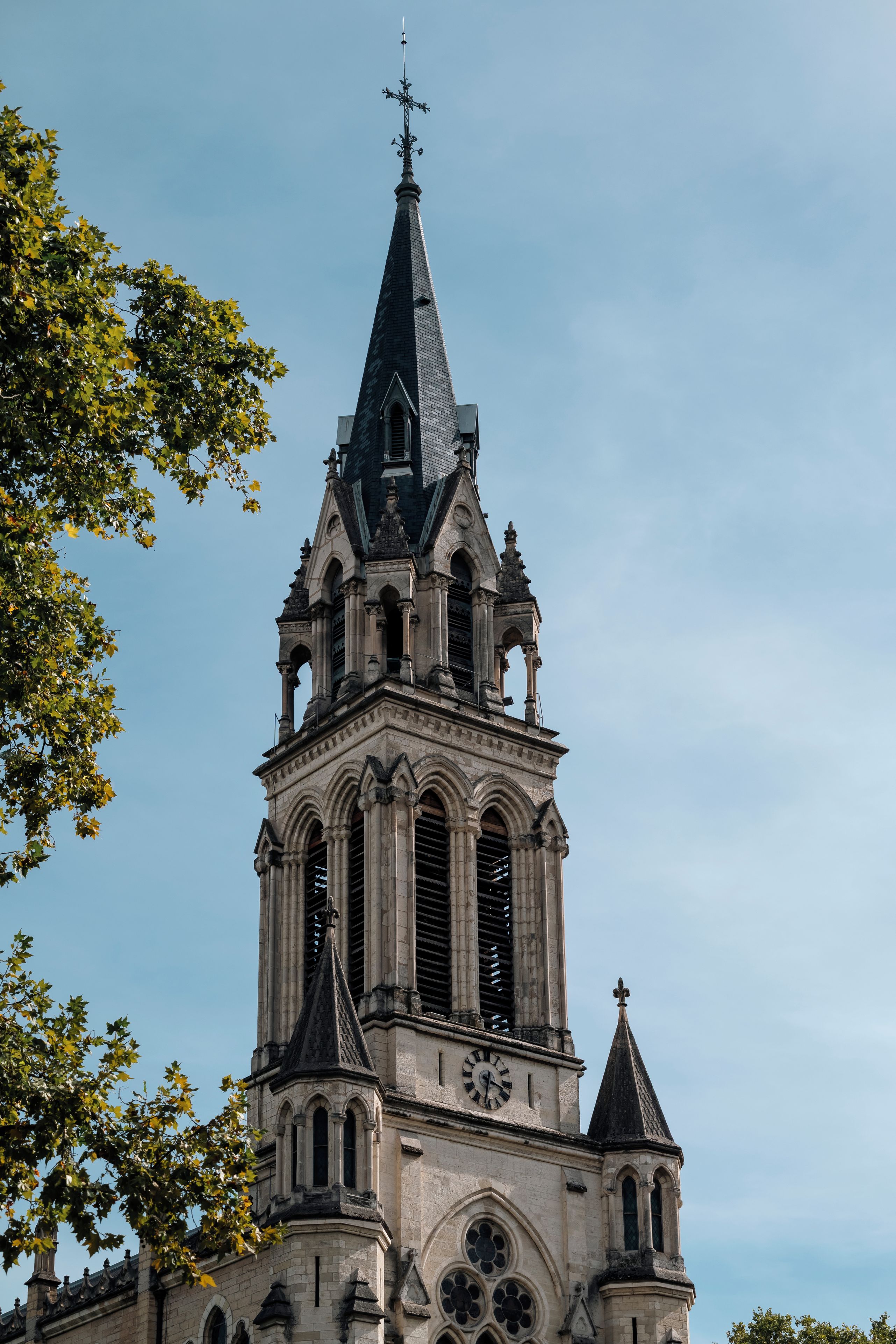 A church with a tall spire and a clock tower.
