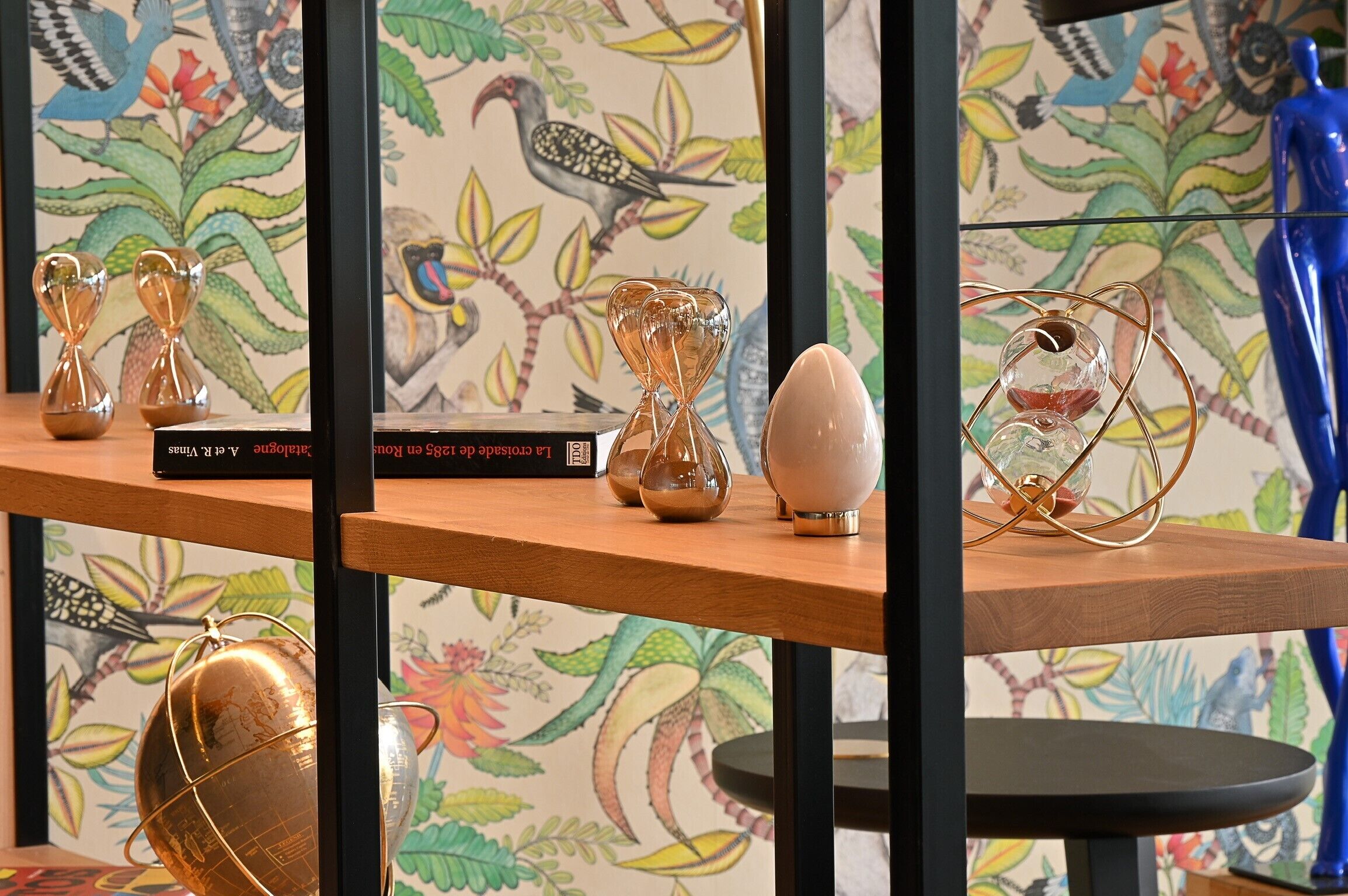 A shelf with decorative glass objects and a globe.