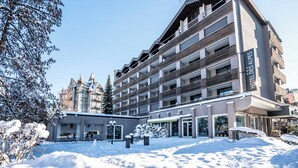 A multi-story hotel with a modern design, featuring balconies and large windows.
