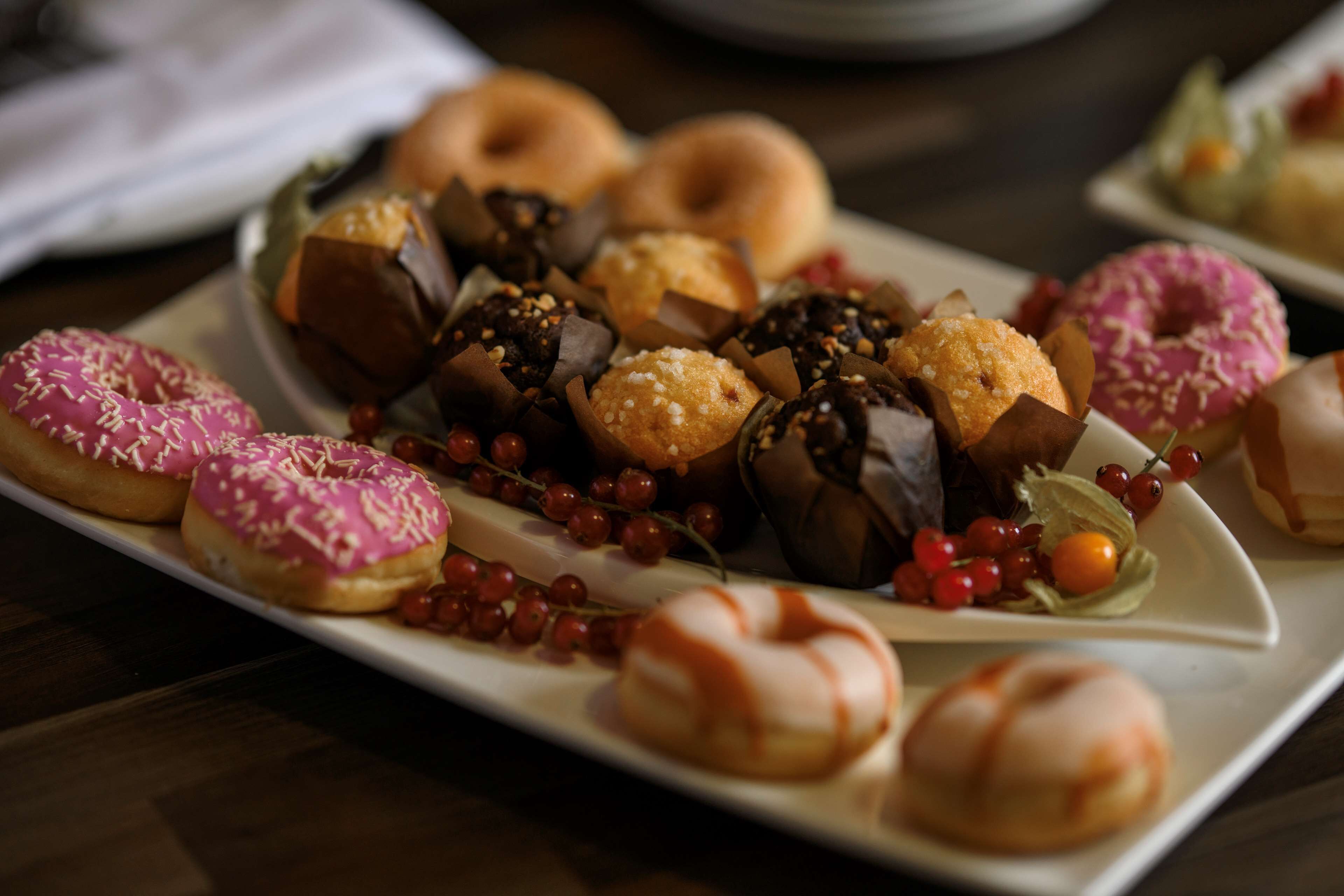 A variety of pastries and donuts on a white plate.