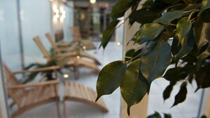 A modern interior with wooden furniture and glass walls. - Golf Hotel Viborg (Viborg)