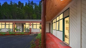 A building with a red exterior, large windows, and a wooden structure. - Gold Rush Inn (Queenstown)