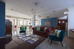 Relax in our inviting lobby, featuring a cozy seating area with a sofa and armchair.