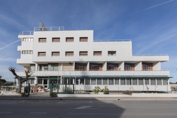 Stylish hotel building with a flat facade and rectangular windows.
