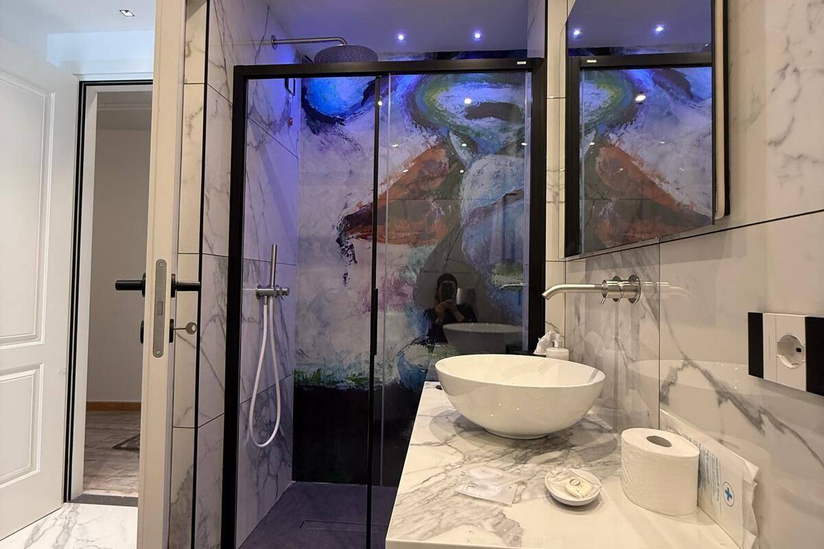 designer toiletries, hair dryer, slippers, bidet