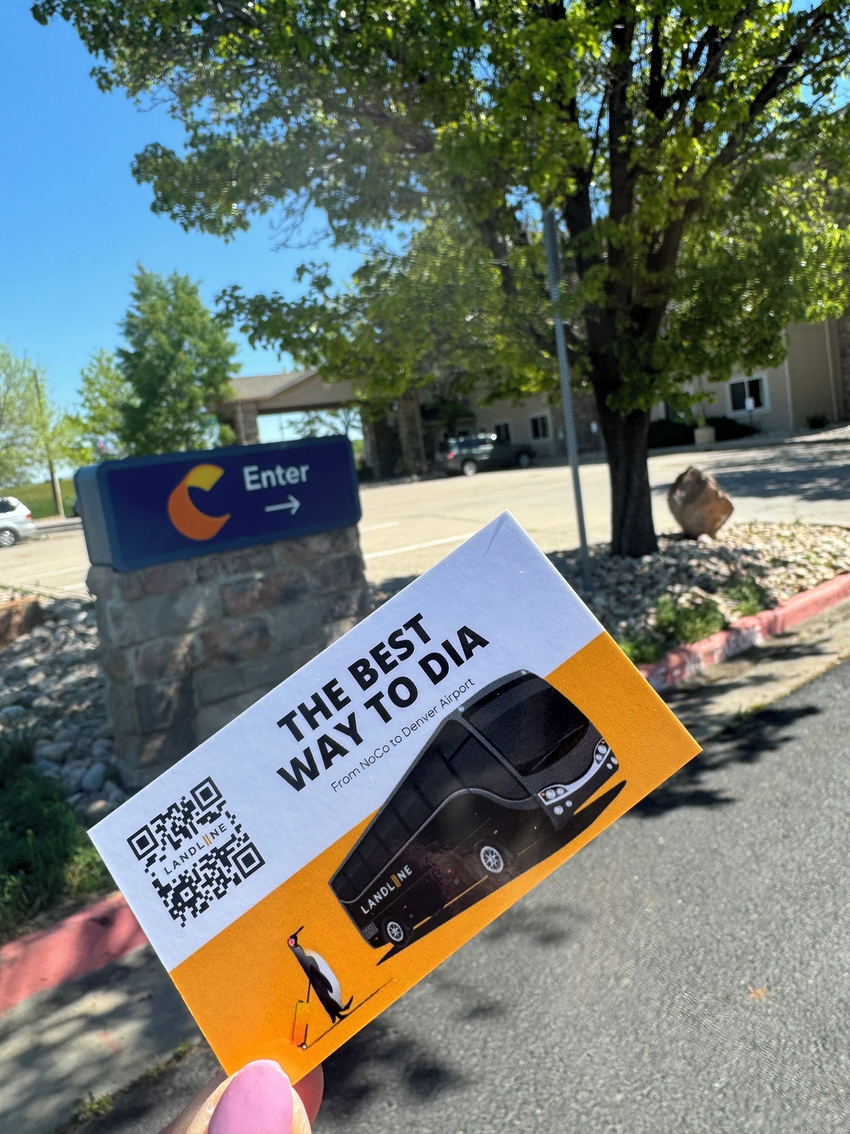 A sign with a car and a QR code, and a card with text and a QR code.