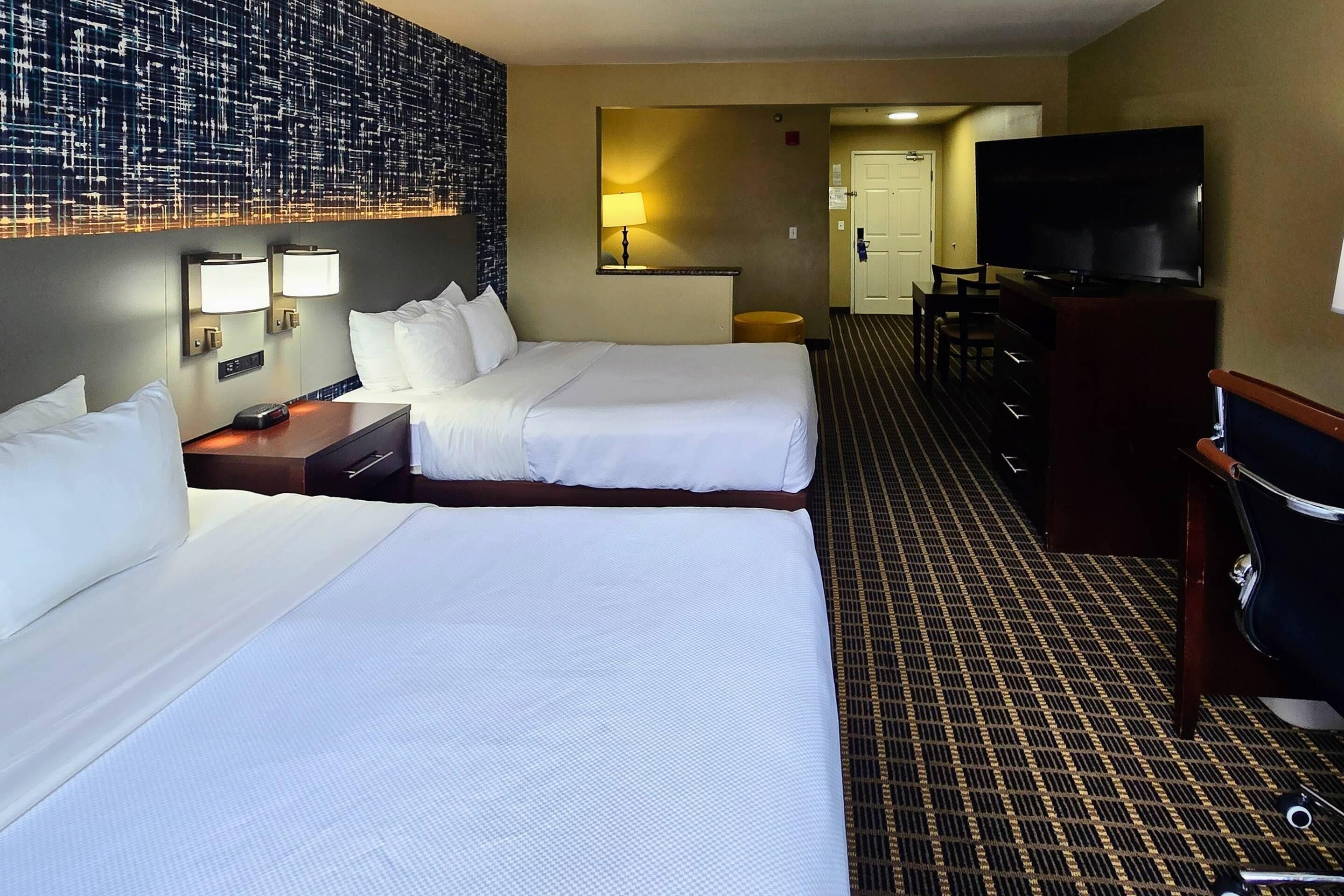 Premium bedding, laptop workspace, blackout drapes, soundproofing
