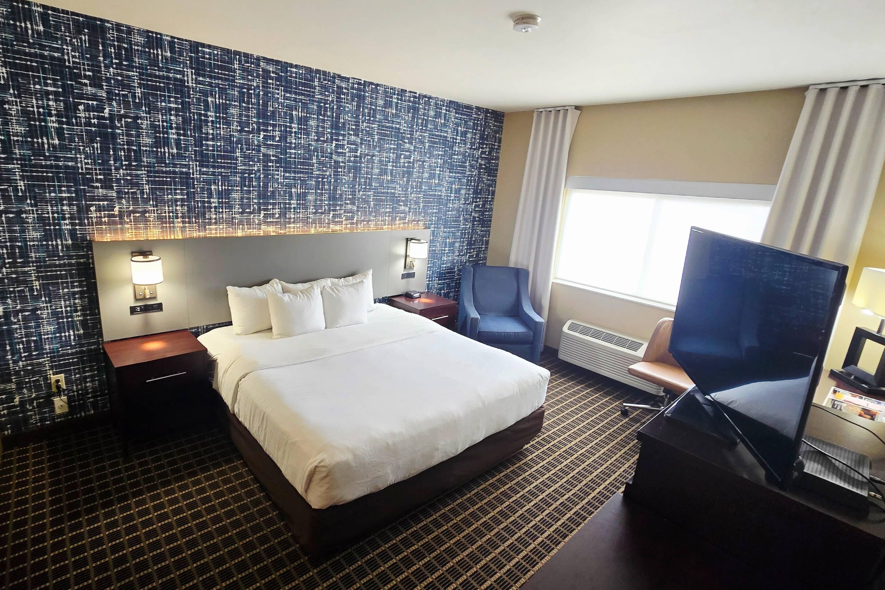 Premium bedding, laptop workspace, blackout drapes, soundproofing