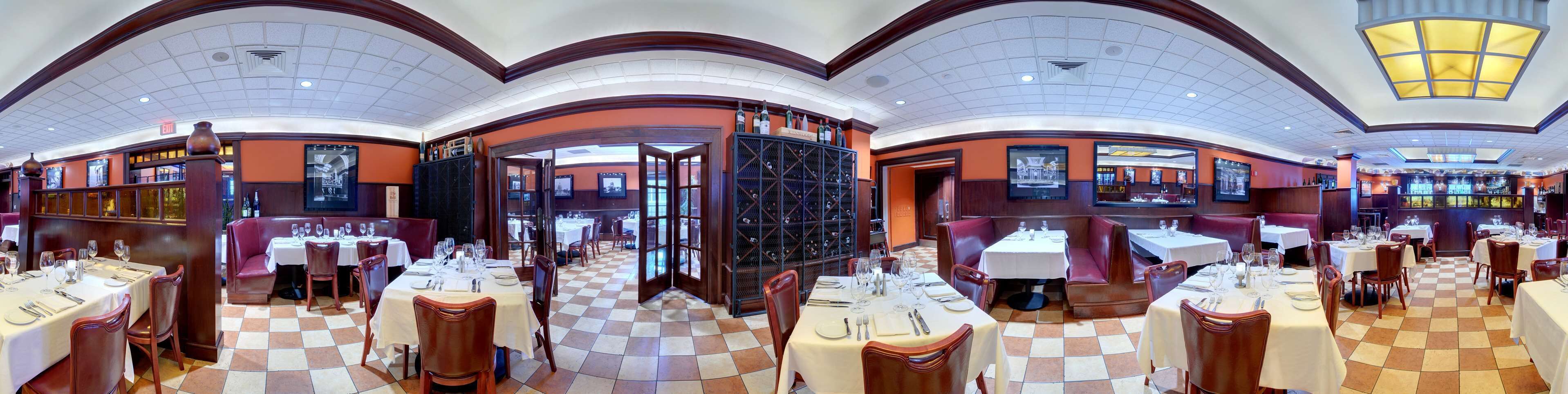 A restaurant with multiple dining areas, each with tables set for guests.