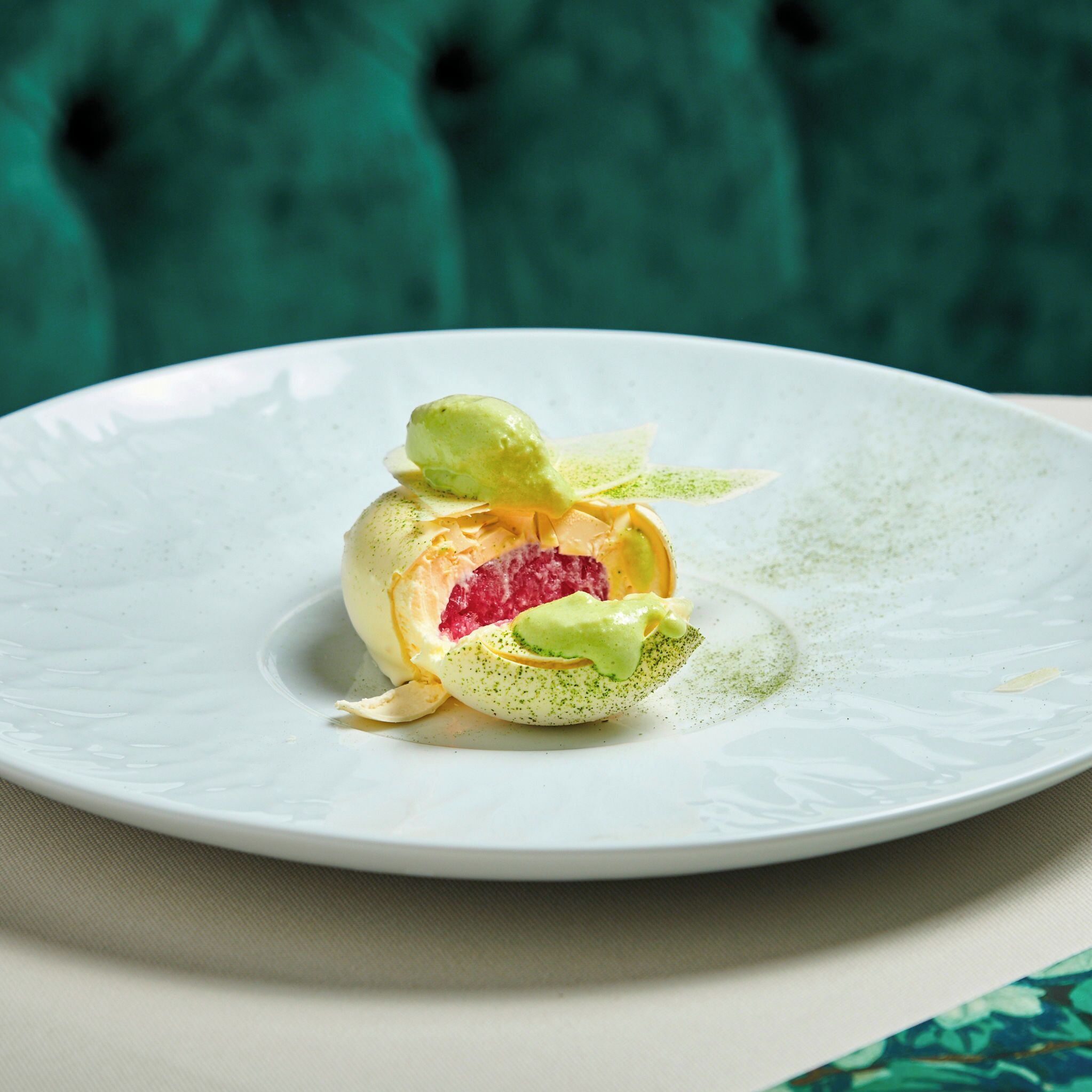A white plate with a food presentation on a table.