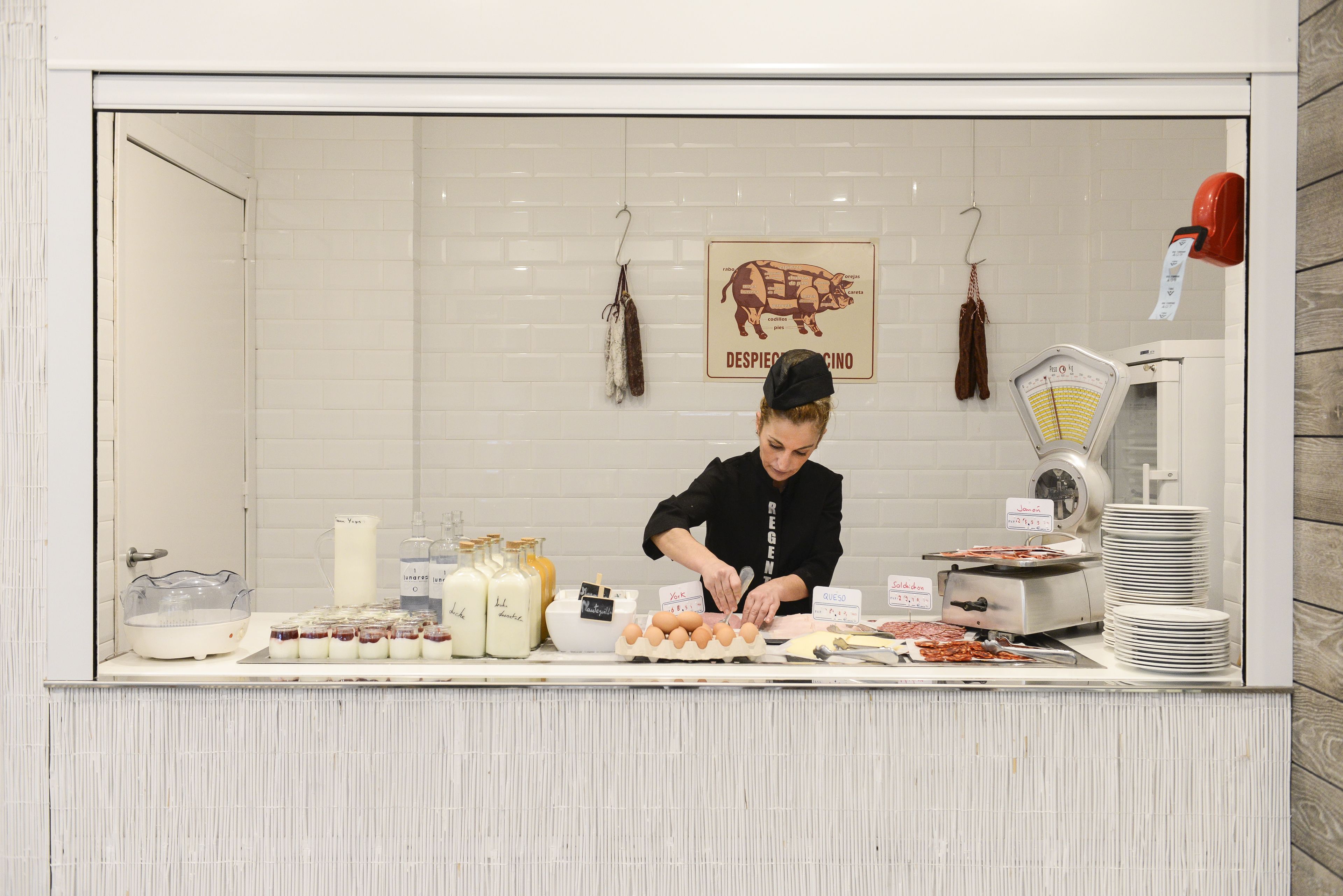 A breakfast counter with various food items and a weighing scale.