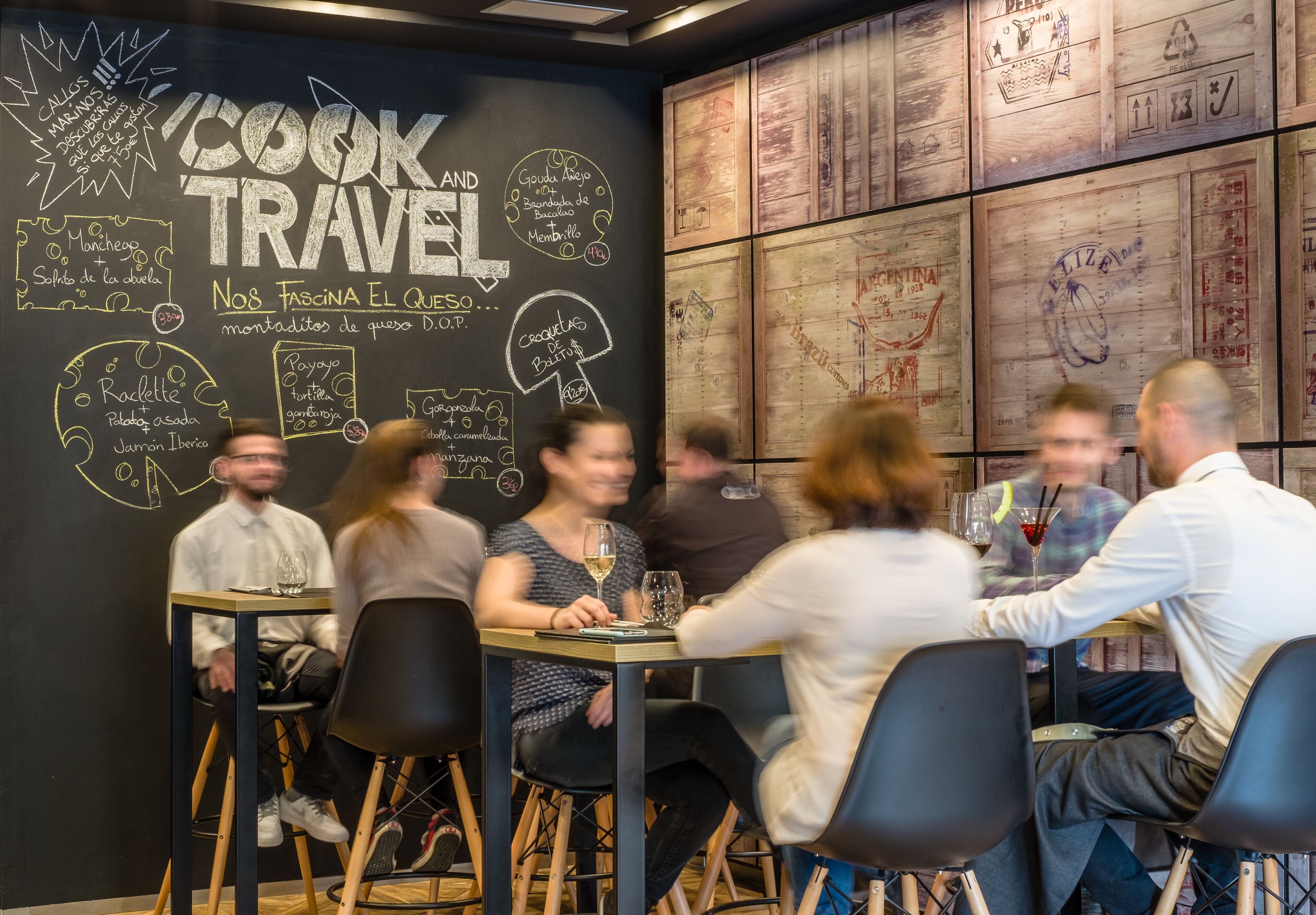 A restaurant with a chalkboard menu and wooden wall decor.