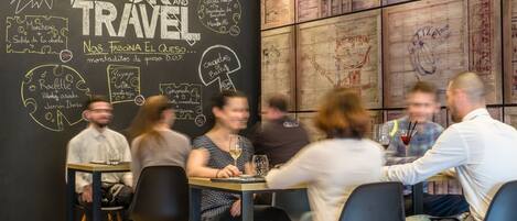 A restaurant with a chalkboard menu and wooden wall decor.