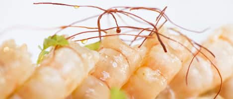 A close-up of a dish with shrimp and garnishes.