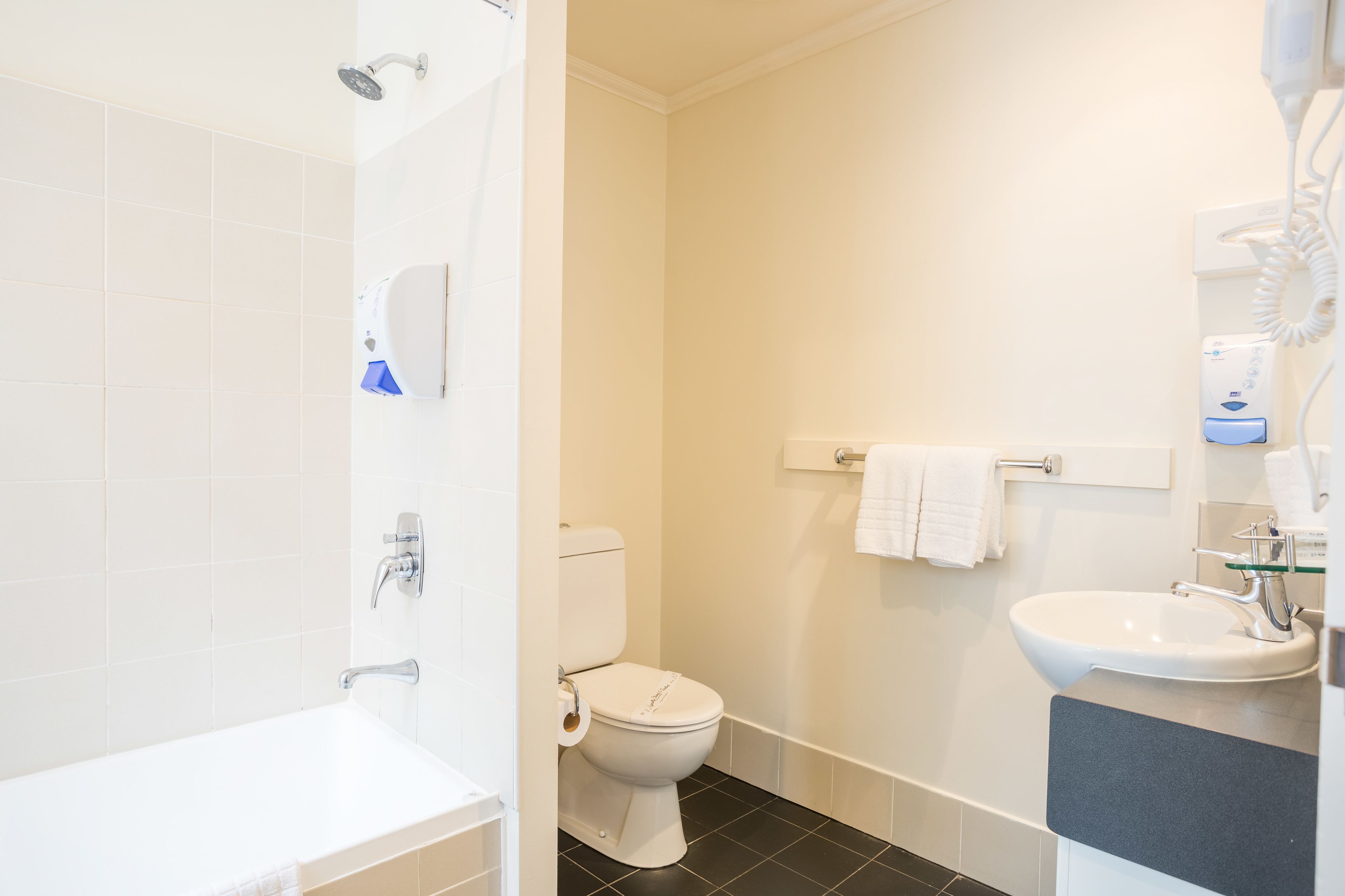 A bathroom with a bathtub, toilet, and sink.