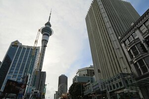 A cityscape with a prominent tower and modern buildings.