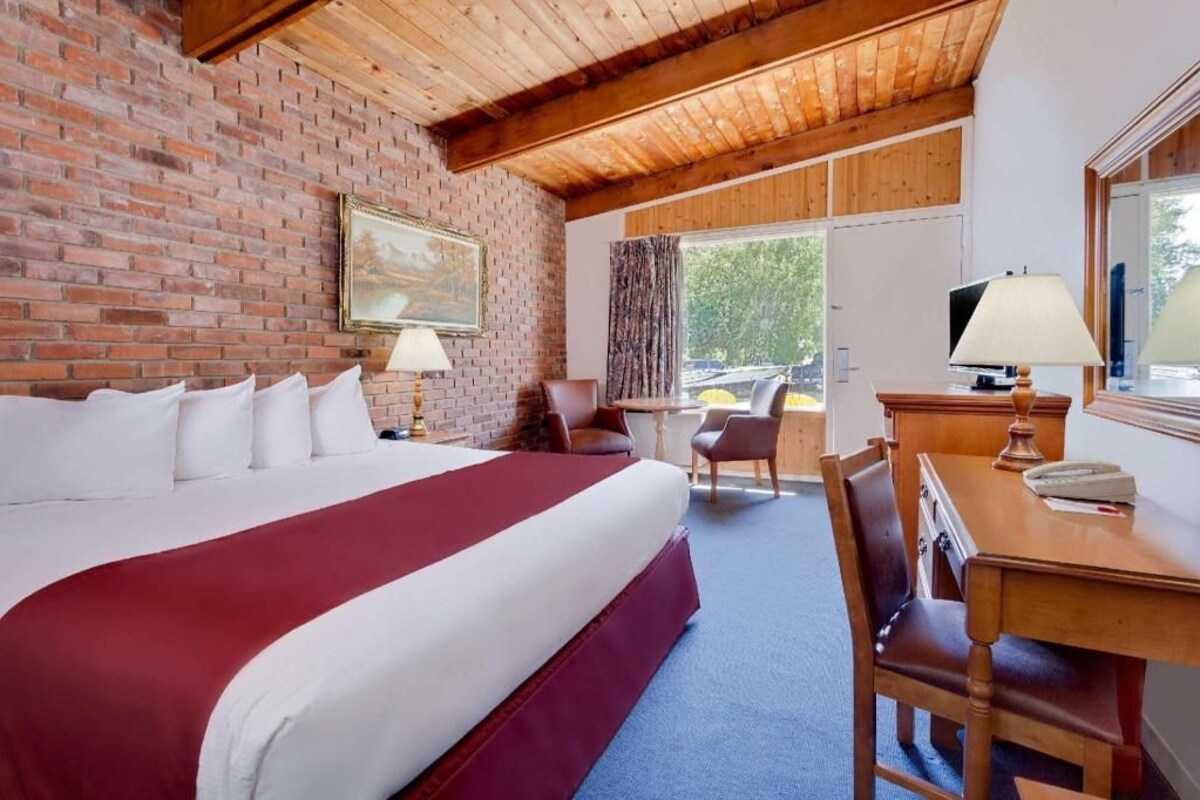 Premium bedding, desk, laptop workspace, blackout drapes