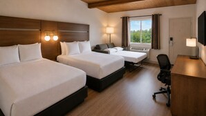 A hotel room with two beds, a desk, a chair, a TV, and a window with a view. - Ramada by Wyndham 1000 Islands/Gananoque (Gananoque)