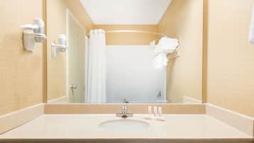 A bathroom with a sink, mirror, towel rack, and shower curtain.