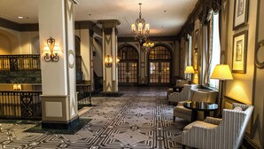 A lobby with patterned flooring, a grand staircase, and elegant furniture. - The Westin Poinsett Greenville (Greenville)
