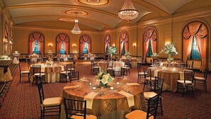 A banquet hall with round tables, chandeliers, and ornate windows. - The Westin Poinsett Greenville (Greenville)