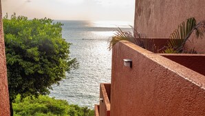 A staircase leading to a terrace with a view of the sea.