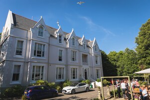 Een groot, wit gebouw met meerdere verdiepingen en een klassieke architectuur, met veel ramen en een opvallende entree.