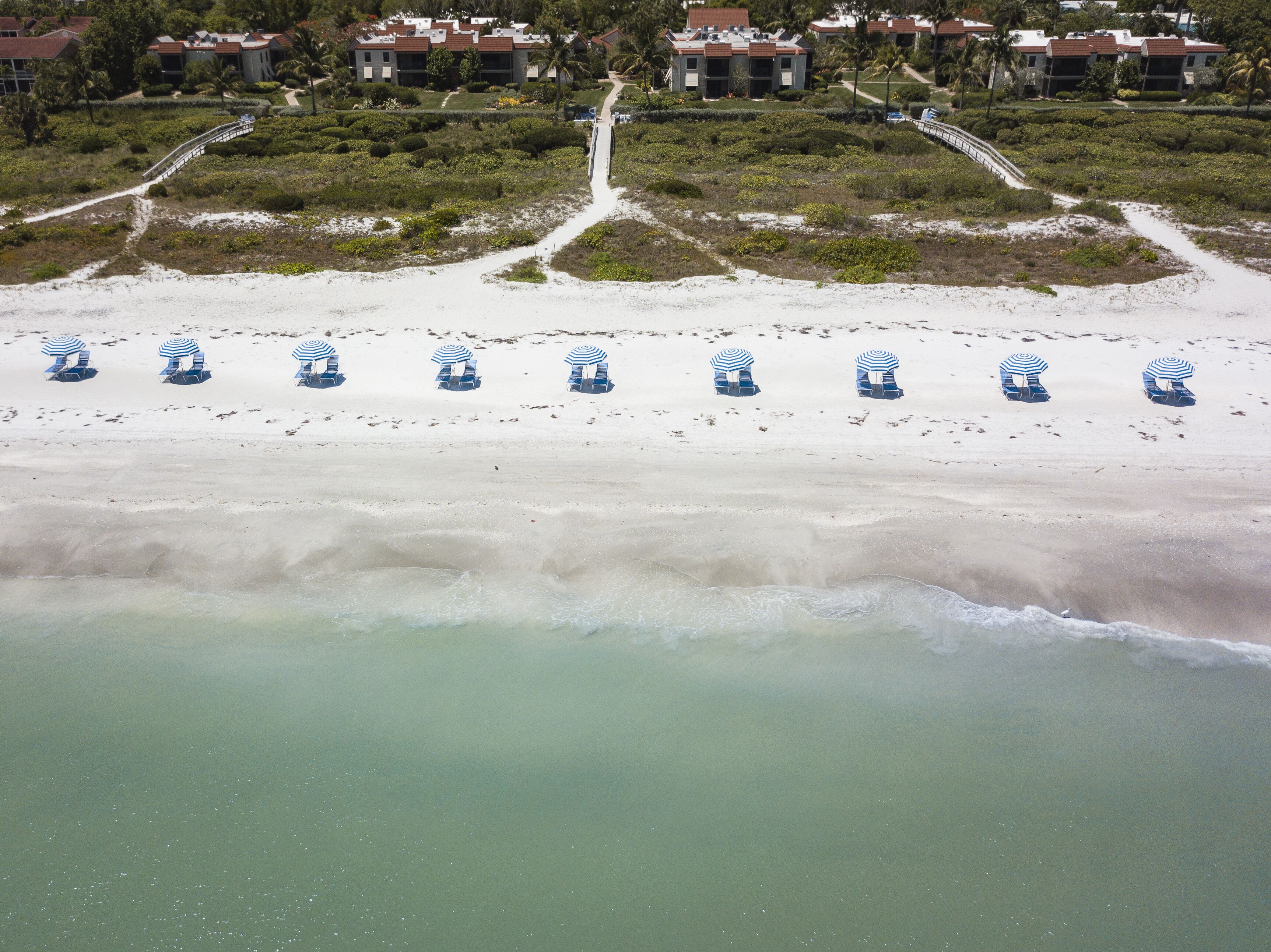 On the beach, white sand, sun loungers, beach umbrellas