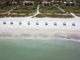 On the beach, white sand, sun loungers, beach umbrellas