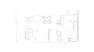 A floor plan of a hotel room with a bed, a desk, a chair, a small table, and a TV.
