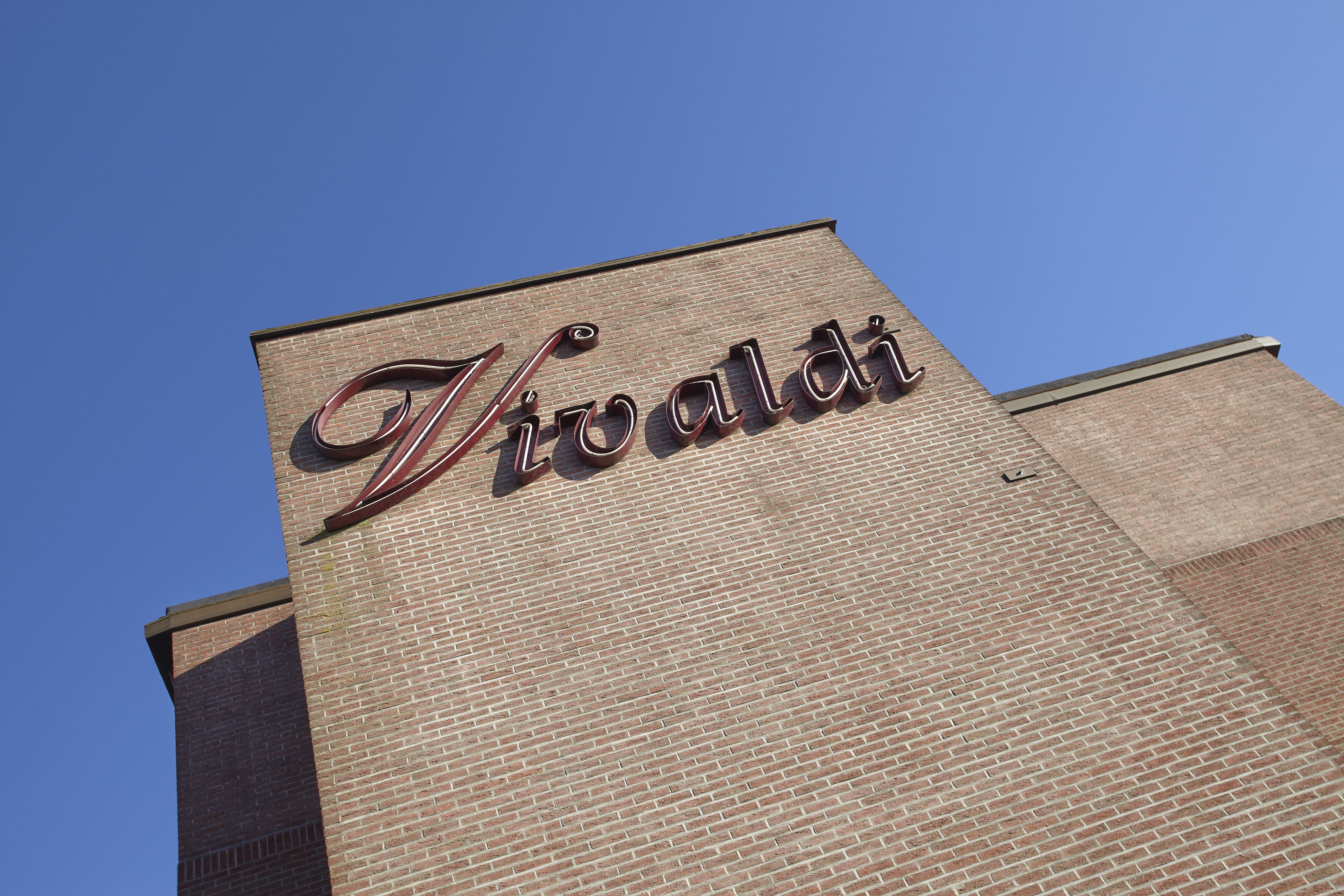 A brick building with the name "Vivaldi" prominently displayed on the facade.