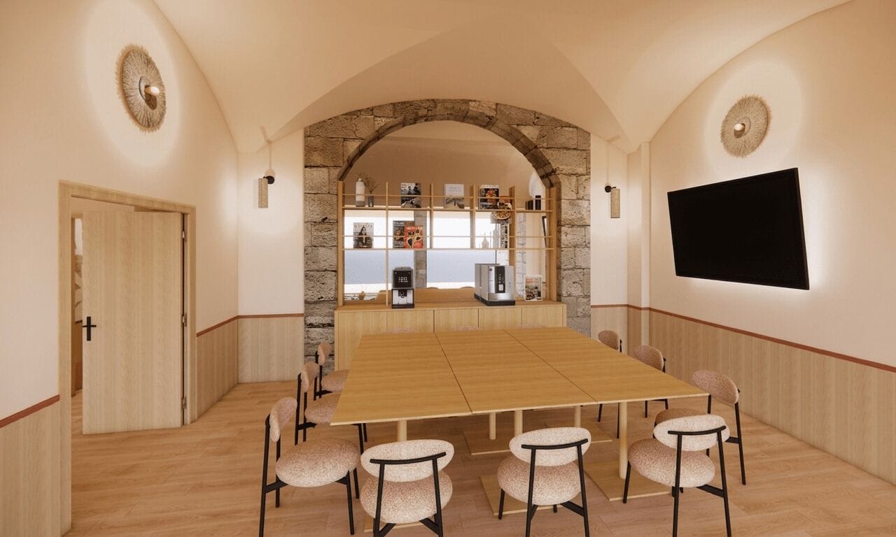 Une salle de conférence avec une longue table, six chaises, une arche en pierre, un téléviseur et une étagère contenant divers objets.