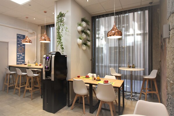 Enjoy meals in this stylish dining area with a central table, pendant lights, and a vertical garden.